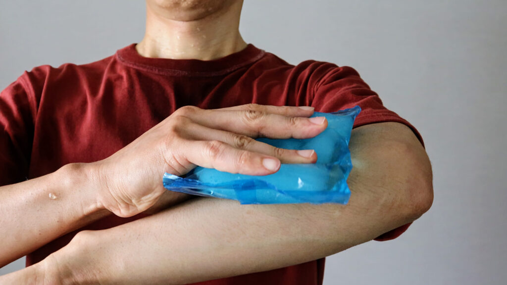 A person cooling their soft tissue injury with ice packs